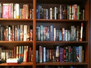 Post thumbnail of On the Booklovers’ Shelves: Objects In Photo More Numerous Than They Appear